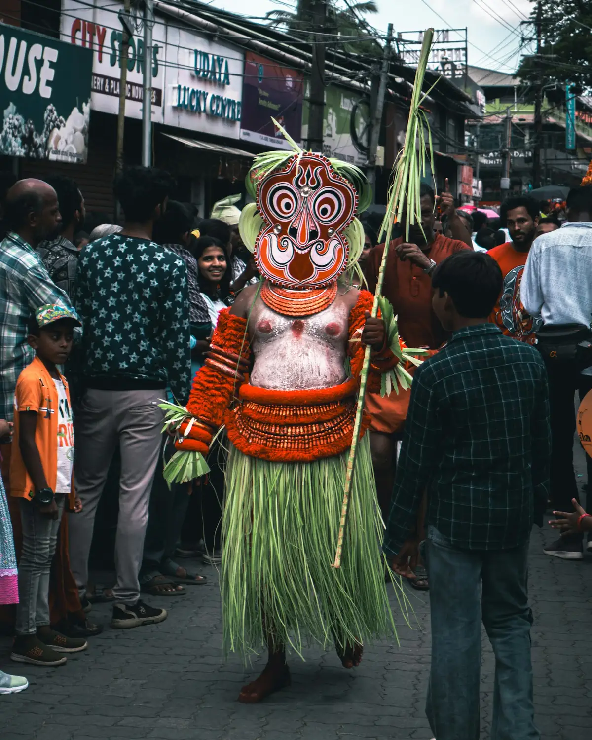 A costumed folk performer in a street procession in Tripunithura, Kerala