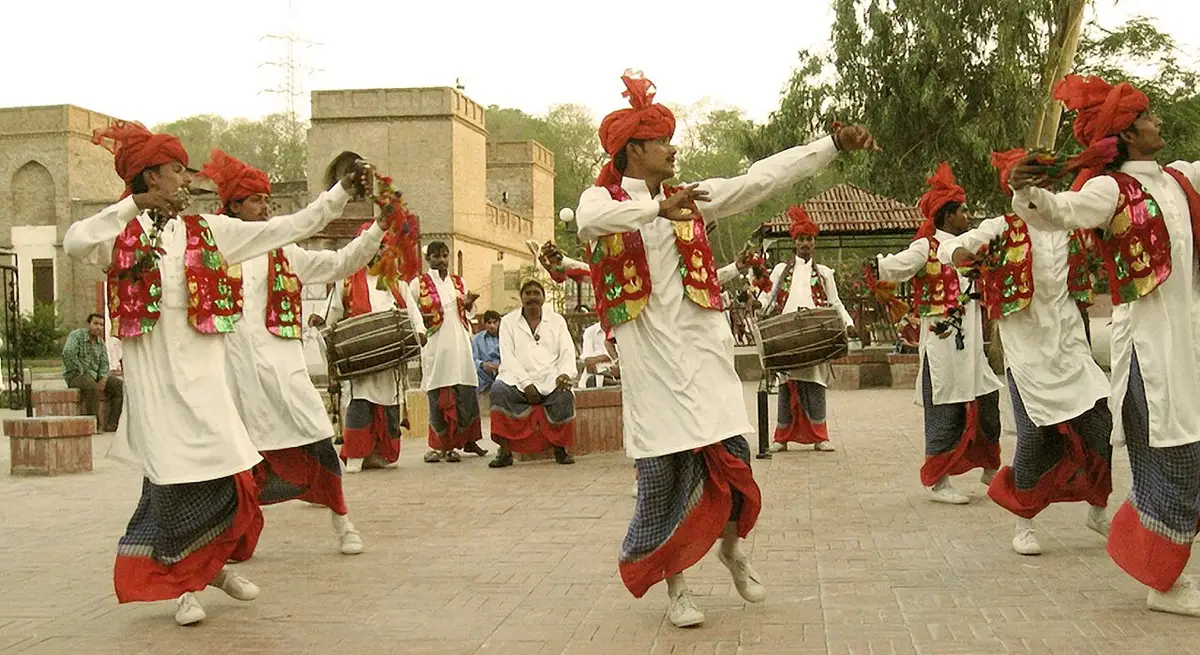 Bhangra dancers in Punjabi dress dancing to the dhol