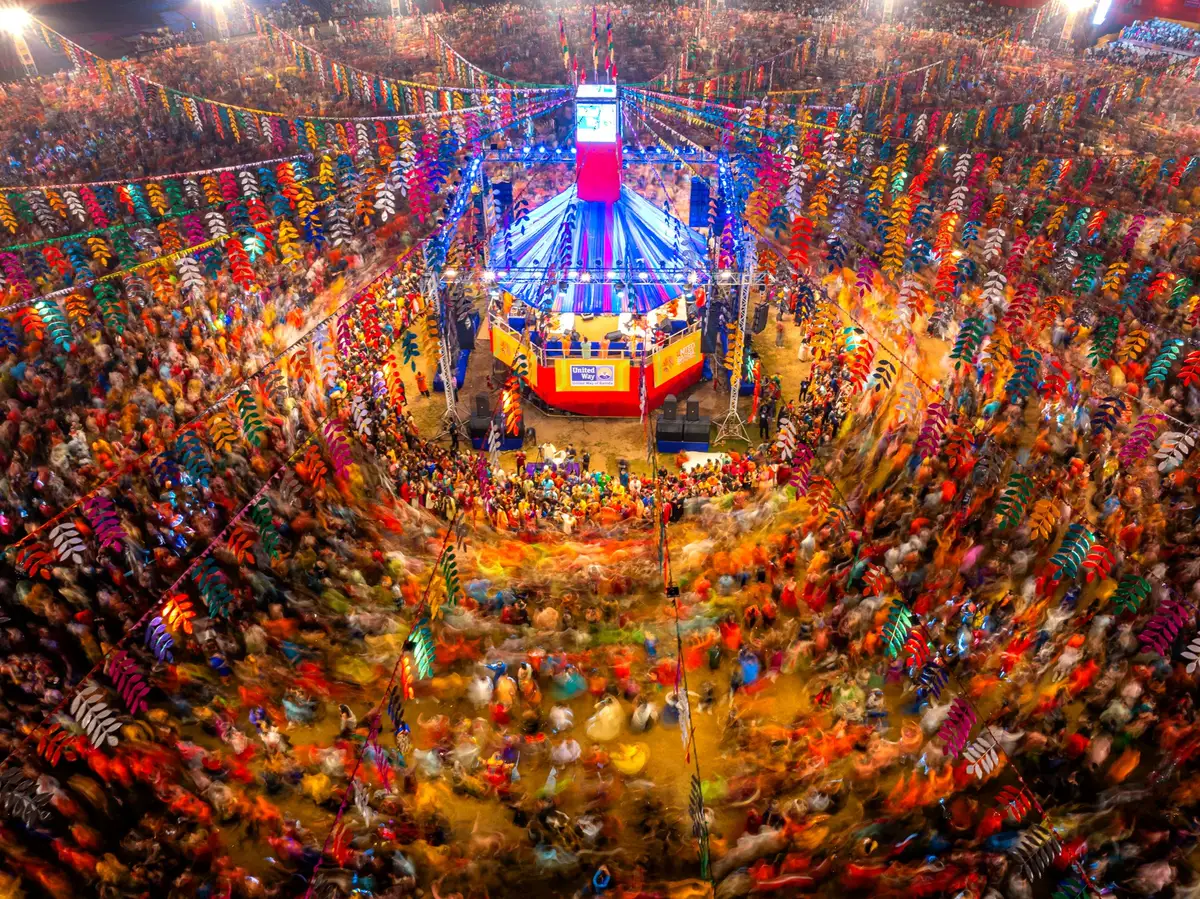 A huge garba circle swirling round a central stage, seen from above